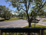 View from Tivoli Apartments balcony showing spacious parking area and landscaped grounds in Virginia Beach, VA.