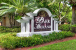 Sign of The Park at Murano apartments in Fort Myers, FL surrounded by lush greenery