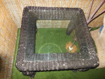 Rattan end table with glass top--- 27"W x 23"H