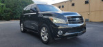 2012 Infiniti QX56 RWD in excellent condition, featuring leather seats and navigation, parked outdoors.