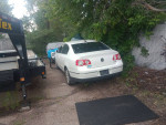 White 2006 Volkswagen Passat parked in a grassy area, needs repair, with clean leather interior.