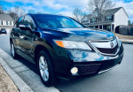 2014 Acura RDX in glossy black, showcasing exterior features, parked in a residential area