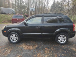 2006 Hyundai Tucson Limited side view with alloy wheels and leather seats, parked outside in nice shape.