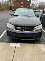2012 Dodge Avenger SXT FWD in parking lot, well maintained with new battery, needs alternator, good condition.