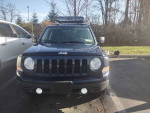 Front view of a clean 2012 Jeep Patriot with a roof rack parked outside in Newburgh