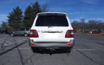 Rear view of a 2006 Toyota Land Cruiser in a parking lot, showcasing its clean design and well-maintained condition.