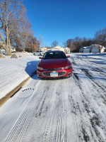 2018 Chevrolet Malibu LT in perfect condition, parked on snowy road, showcasing its sleek design and low mileage.
