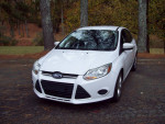 2013 Ford Focus SE Hatchback, clean exterior, parked in natural setting, showcasing low mileage and excellent condition.
