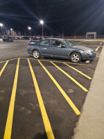 2005 Dodge Stratus sedan parked in a lot with yellow parking lines, featuring clean exterior and good condition.