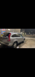 2008 Honda CRV for sale, silver SUV parked at night with visible wear and tear.