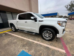 2020 GMC Sierra 1500 Denali white truck parked, featuring chrome wheels and clean paint, with 63,000 miles.
