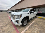 2020 GMC Sierra 1500 Denali 4WD in white parked outside, showing chrome accents and excellent condition.