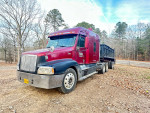 2002 Freightliner Century Class truck with dump trailer, showcasing exterior and surroundings.