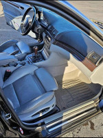 Interior view of a 2002 BMW 3 Series 330xi AWD with leather seats and modern dashboard features.
