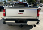 Rear view of a GMC Sierra SLE truck with a grey cloth interior and 4x4 capabilities.
