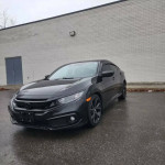Black Honda Civic Sport with sport-tuned suspension and alloy wheels parked on pavement