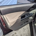 Interior view of Honda CR-V door showing window controls and clean upholstery.