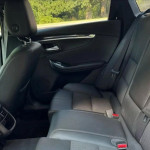 Interior view of a Chevrolet Impala's back seat, featuring modern upholstery and spacious design.