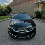 Black Chevrolet Impala with clean title, push start, and financing available parked in a residential area.