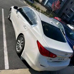 White INFINITI Q50 sedan parked, featuring black interior and clean title for sale.