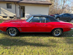 1969 Pontiac Firebird convertible in red, showcasing its classic design and excellent paint job
