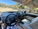 Interior view of a 2005 Toyota Prius hatchback with gray seats and dashboard features.