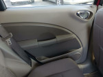 Interior view of a 2006 Chrysler PT Cruiser, showcasing gray upholstery and door panel details.