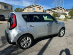 2014 Kia Soul wagon in silver color parked on the street, showcasing its sleek design and alloy wheels.