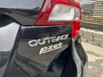 Close-up of the rear badge of a 2017 Subaru Outback, showcasing the Outback and PZEV logos.