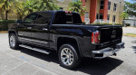 2018 GMC Sierra 1500 SLT 4x4 Z71 pickup truck in excellent condition with black paint and polished aluminum wheels.