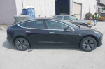 Side view of a black 2020 Tesla Model 3 Standard Range Plus with 49,256 miles, a stylish electric sedan.