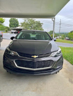 Front view of a 2014 Chevrolet Cruze 1LT in good condition for sale, parked under a carport.