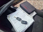 Close-up of documents and keys inside a 2019 Honda Accord Sport for sale, highlighting its condition.