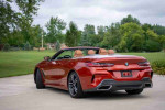 2020 BMW M850i xDrive convertible in Sunset Orange parked outdoors, showcasing its sleek design and luxury features.