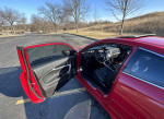 Interior view of a 2014 Honda Accord EX, red exterior, black seats, parked in a scenic area.