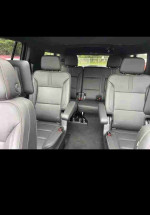 Interior view of a 2021 Chevrolet Suburban LS showcasing spacious leather seating with a modern design.