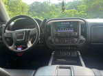 Interior view of a 2014 GMC Sierra 1500 showing dashboard and multimedia display.