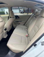 Interior view of a 2015 Honda Accord EX showing clean beige leather seats and spacious backseat area