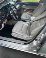 Interior view of a 2012 Honda Accord EX-L V-6 with light gray leather seats and modern dashboard.