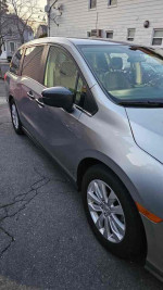 Side view of a 2018 Honda Odyssey LX, a clean 7-seater minivan with automatic features and rear view camera.