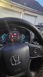 Interior view of 2018 Honda Odyssey LX with dashboard and steering wheel visible, showing clean and functional setup.