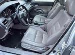 Interior view of a 2012 Honda Accord EX-L V-6 with gray leather seats and dashboard features.