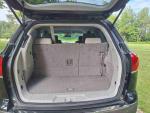 Interior view of the cargo space in a 2012 Buick Enclave SUV with foldable seats.