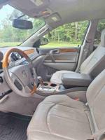 Interior view of a 2012 Buick Enclave SUV with leather seating and wooden accents.