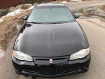Front view of a 2004 Chevrolet Monte Carlo SS Intimidator, sleek black exterior, showcasing its classic design.