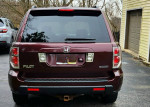 2007 Honda Pilot EX FWD, rear view showcasing design features in a driveway setting.