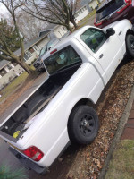 2010 Ford Ranger with low mileage, clean interior, and ready for work, parked on a street near residential homes.