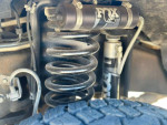 Close-up view of the suspension spring and shock absorber in a 2015 Ford F350 Lariat truck