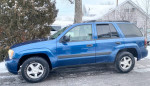 2006 Chevrolet TrailBlazer in blue parked in snow, reliable 2WD SUV with 95,000 miles on the odometer.