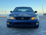 Front view of a 2003 Lexus IS 300 RWD, highlighting its worn paint and headlights, available for sale.